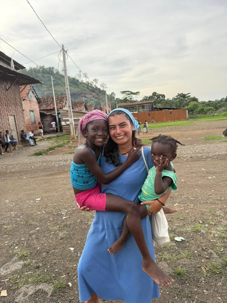 Teresa Roquette, voluntária da Associação BAOBÁ, com crianças em São Tomé e Príncipe